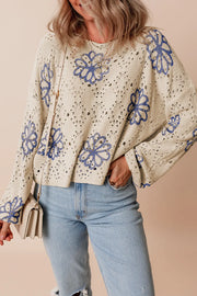 Beige floral embroidered eyelet knit pullover sweater with blue floral details.