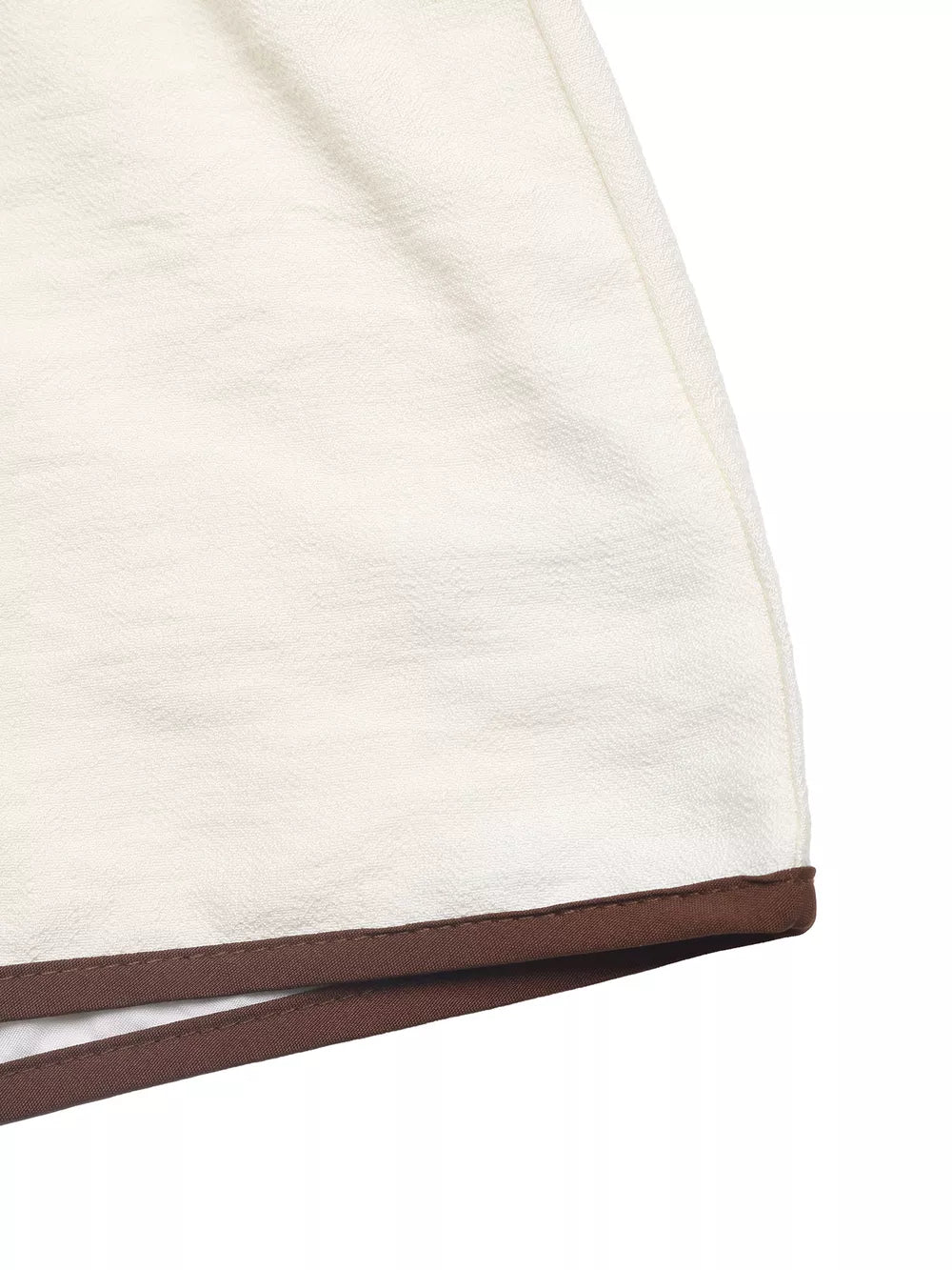 Chic tie-front two-piece ensemble in beige with brown trim detail.