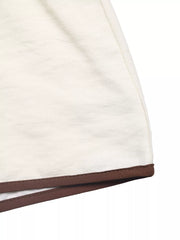 Chic tie-front two-piece ensemble in beige with brown trim detail.