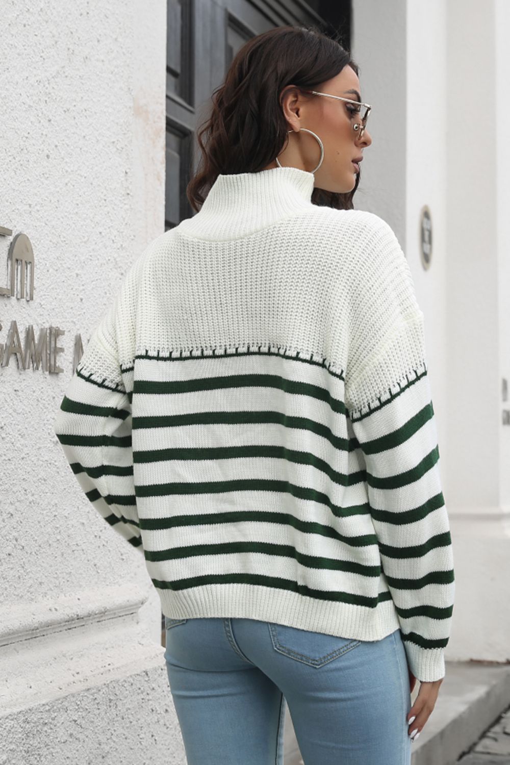 Turtleneck sweater with green and white Breton stripes and acrylic knit.