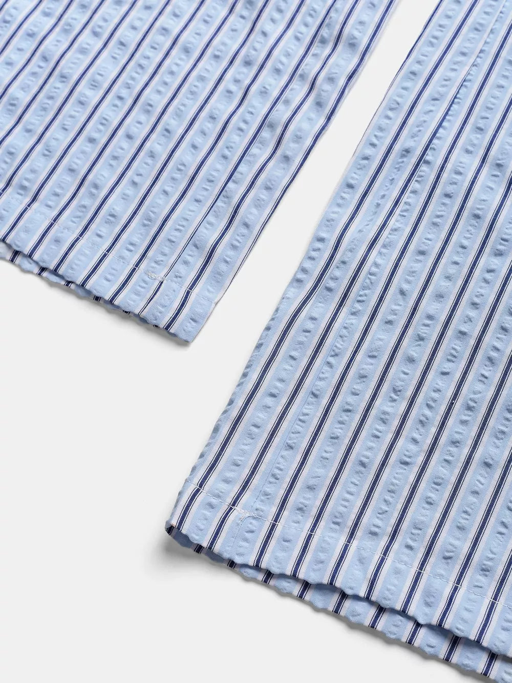 Maternity wide-leg pants in blue and white vertical stripes with textured fabric detail.