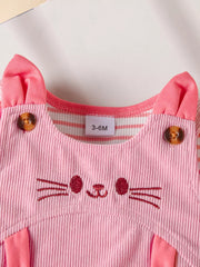 Pink corduroy baby dress with cat face embroidery and striped sleeves.