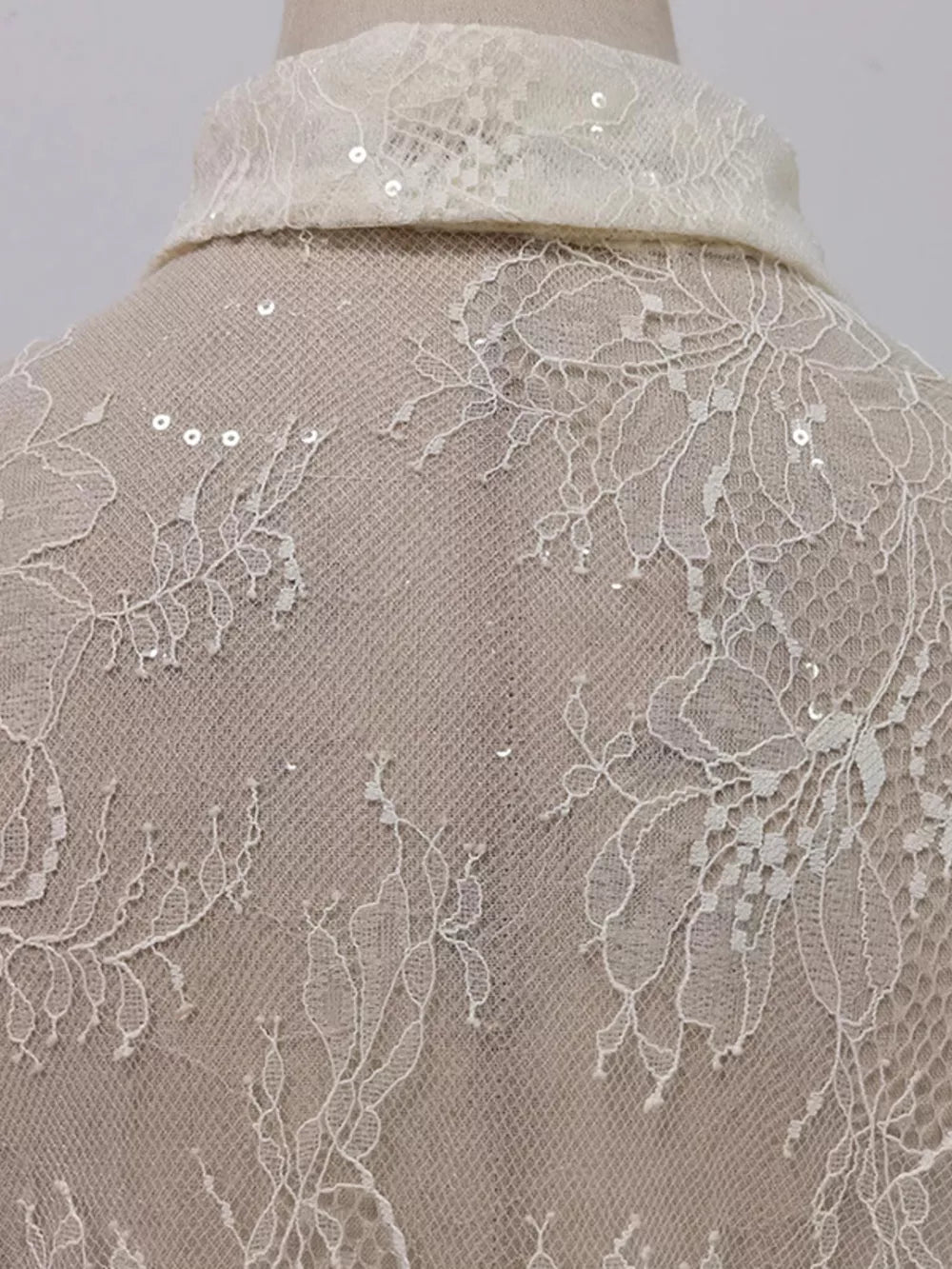 Floral lace dress detail with sequins on collar and back.