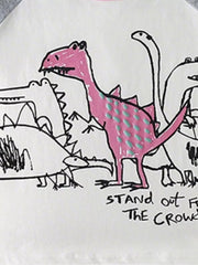 Toddler t-shirt with playful dinosaur print, featuring a pink dinosaur with teal dots and text.