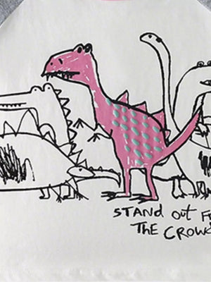 Toddler t-shirt with playful dinosaur print, featuring a pink dinosaur with teal dots and text.