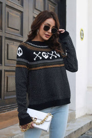 Black crewneck sweater with skull and crossbones jacquard pattern, acrylic knit, casual style.