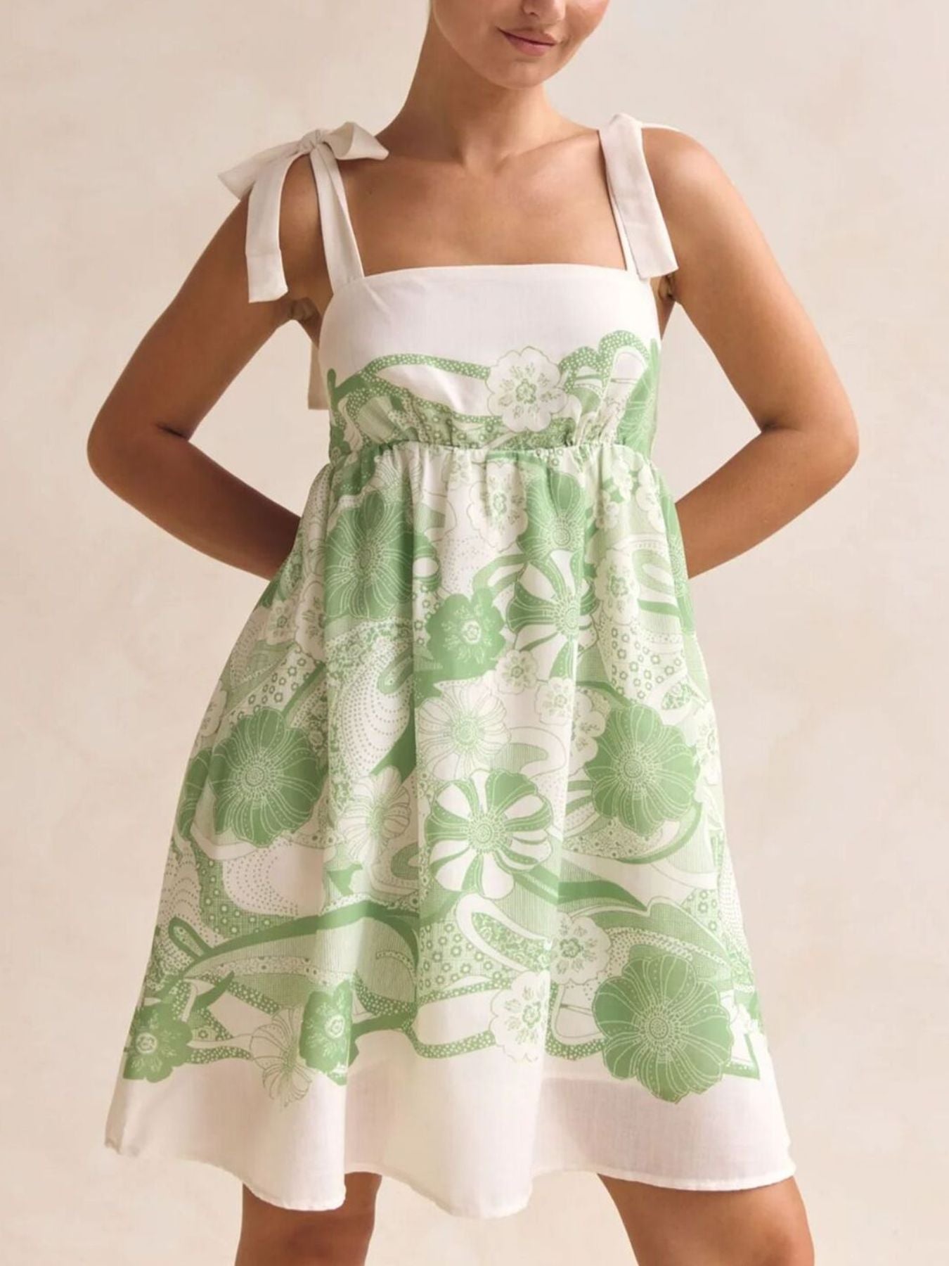 Green floral tie-strap mini dress with square neckline and pockets