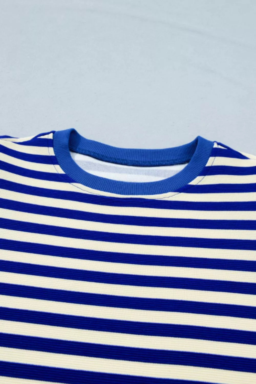Blue and cream striped polyester top with crew neck and ruffle sleeves