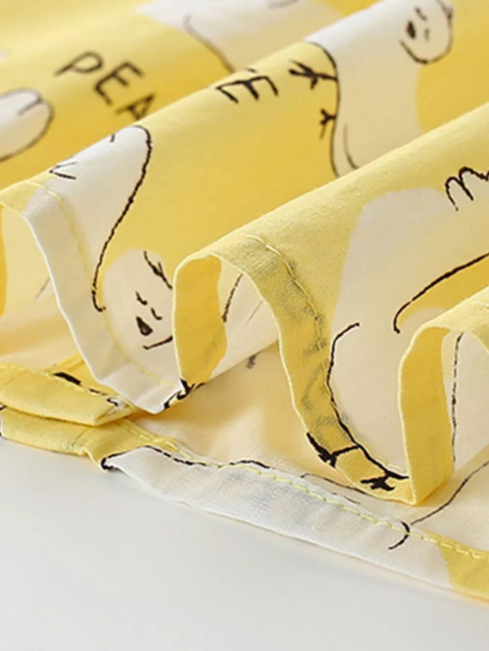 Toddler dress in yellow cotton blend with a dove print and ruffle sleeves.