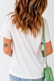 White crew neck tee with rolled sleeves and a subtle eye tattoo detail on the arm.