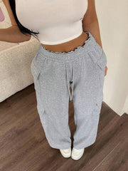 Relaxed fit gray cargo pants with drawstring waist and cargo pockets.