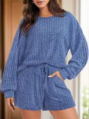 Dusty blue ribbed knit loungewear set with crewneck sweater and shorts with pockets and drawstring waist.