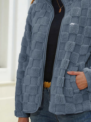 Textured grid zip-up jacket in grey, with a fuzzy fleece material and zip pockets.