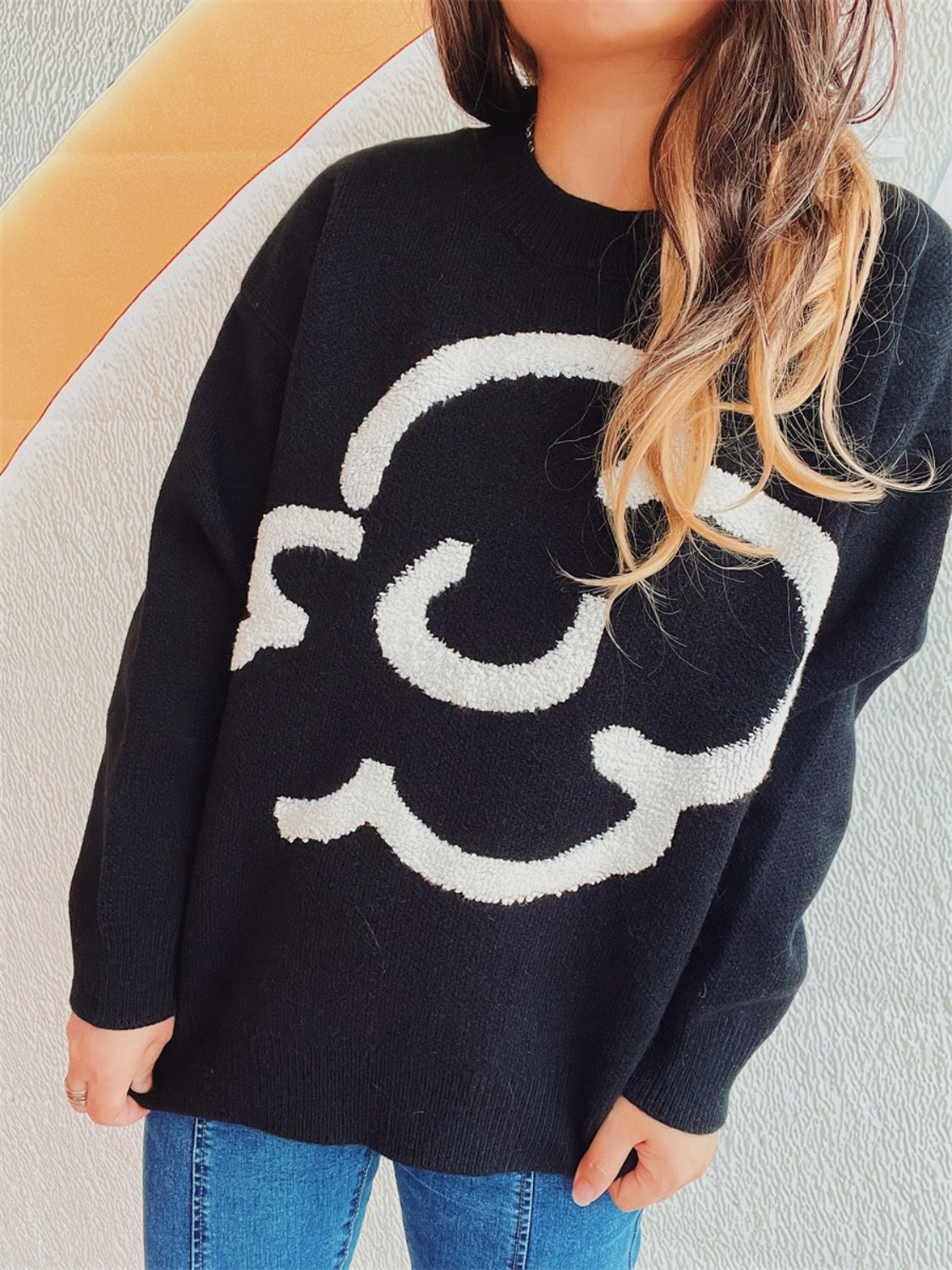 Black acrylic sweater with white cloud intarsia knit pattern, crew neck, long sleeves.