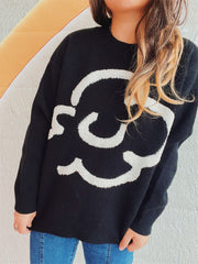 Black acrylic sweater with white cloud intarsia knit pattern, crew neck, long sleeves.