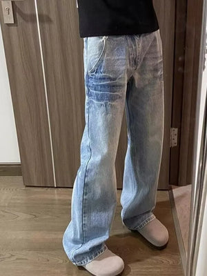 Men's light wash wide-leg jeans with vintage distressing and a relaxed fit.