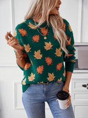 Green knit jumper with autumnal leaf motif, crew neck, long sleeves, and ribbed cuffs.