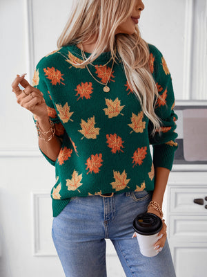 Green knit jumper with autumnal leaf motif, crew neck, long sleeves, and ribbed cuffs.
