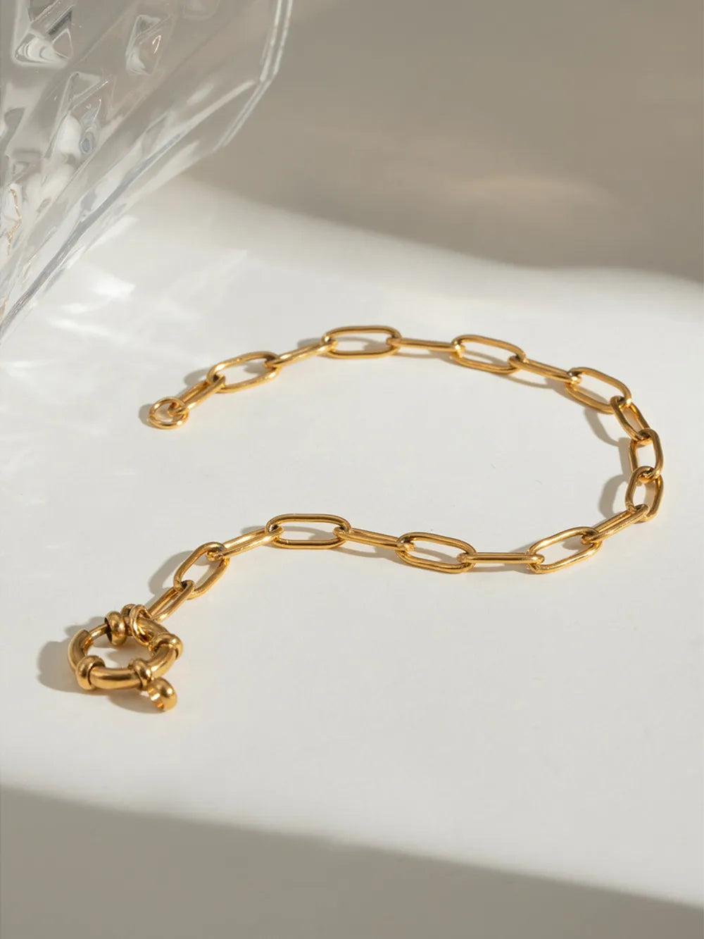 Gold chunky link bracelet with a circular toggle clasp