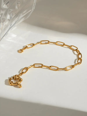 Gold chunky link bracelet with a circular toggle clasp
