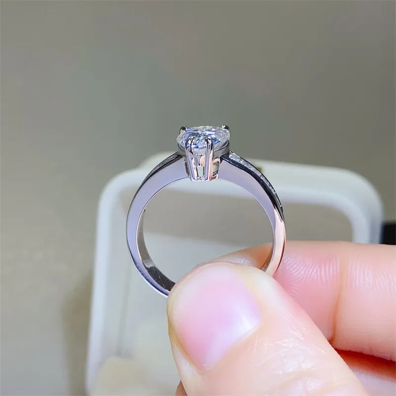 Silver pear cut moissanite ring with baguette accents