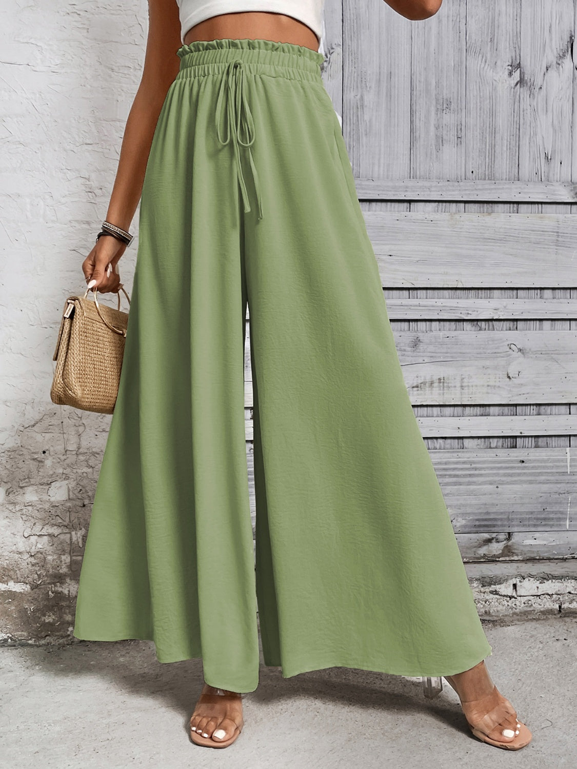 Light green ruffled waistline palazzo trousers with drawstring and wide leg