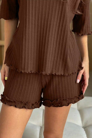Brown ribbed pajama set with ruffled trim on short sleeves and hem of shorts.