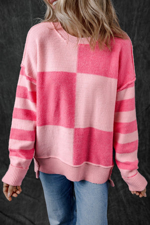 Checkerboard knit crewneck sweater in blush pink with striped sleeves.