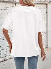 White cotton oversized tee with seam detail and a back label detail.