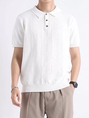 White textured cotton blend short-sleeve polo with button detail and classic collar.