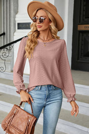 Textured puff sleeve blouse in Dusty Pink with ruffle cuffs and a diamond pattern.