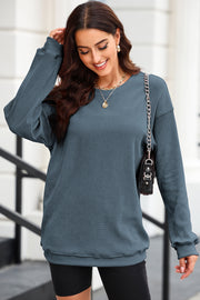 Textured ribbed crewneck pullover in Dusty Blue with long sleeves and a relaxed fit.