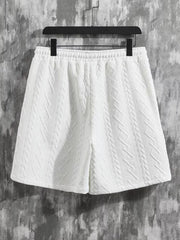 White knit shorts with textured diamond pattern and elastic waistband