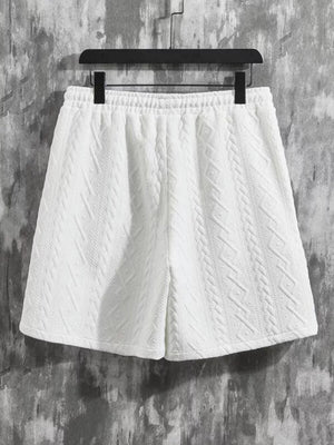 White knit shorts with textured diamond pattern and elastic waistband