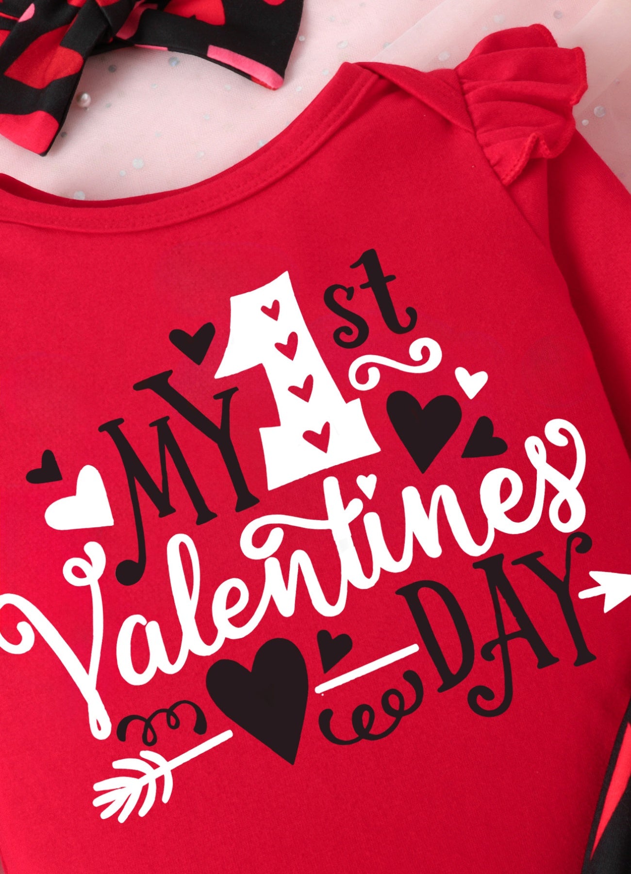 Red baby bodysuit with ruffled sleeves and "My 1st Valentines Day" graphic.