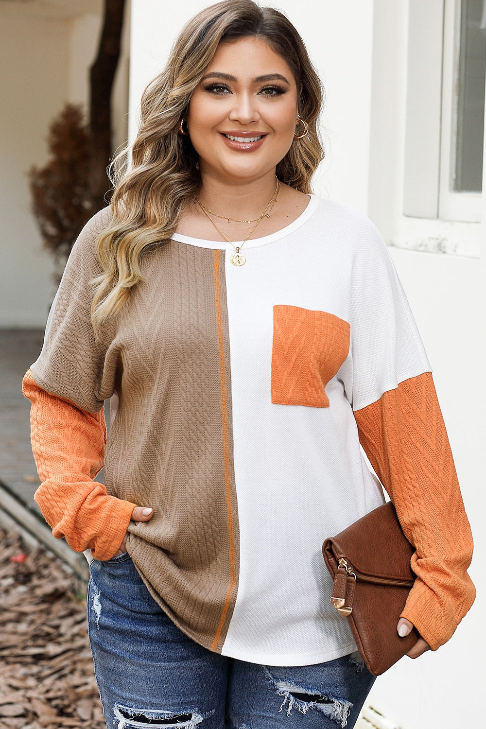 Colorblock knit pocket tee in taupe and white with orange sleeves and pocket detail.