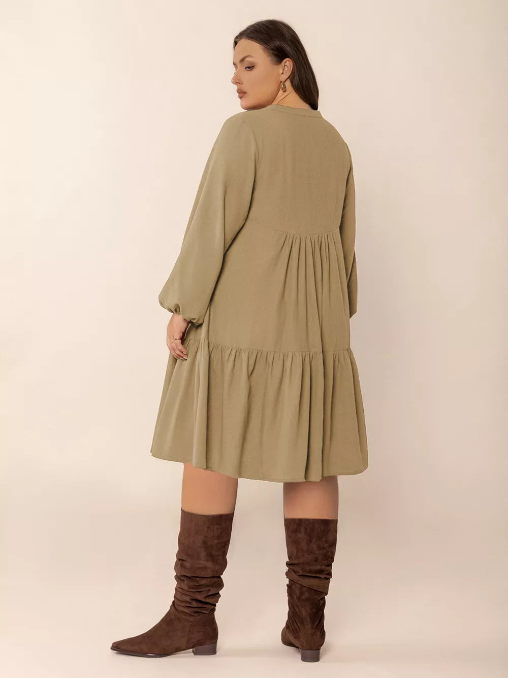 Olive green tie-neck dress with balloon sleeves, tiered skirt, and button front.