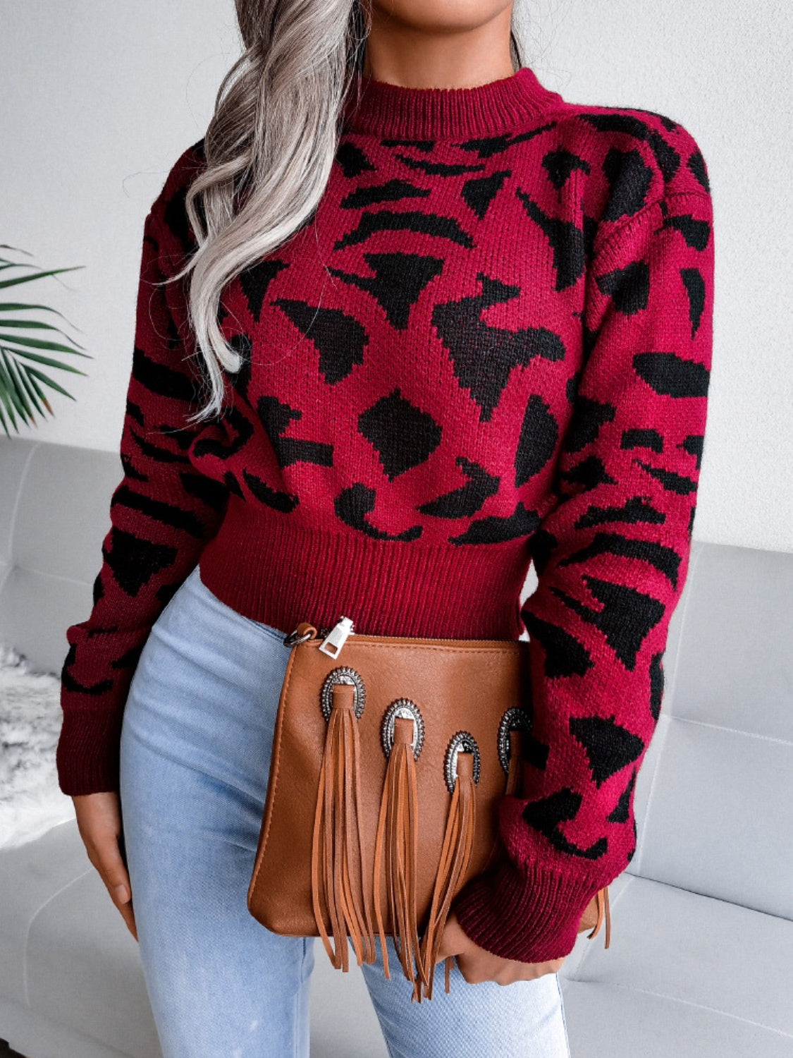 Crimson abstract knit cropped sweater with mock neck and long sleeves.