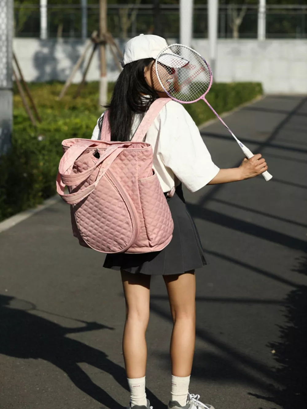 Pink quilted sports racket backpack with diamond pattern and luxe design.