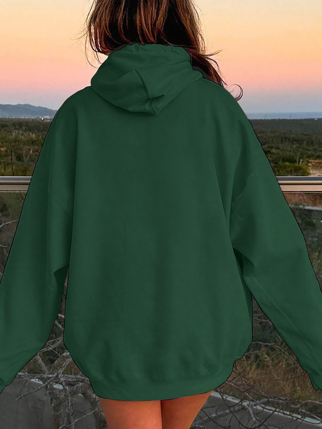 Oversized dark green hoodie with a pouch pocket and hood, shown from the back.