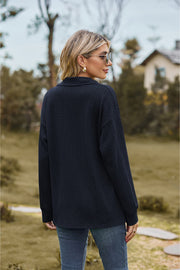 Dark Blue textured cable knit polo top with collar and long sleeves.