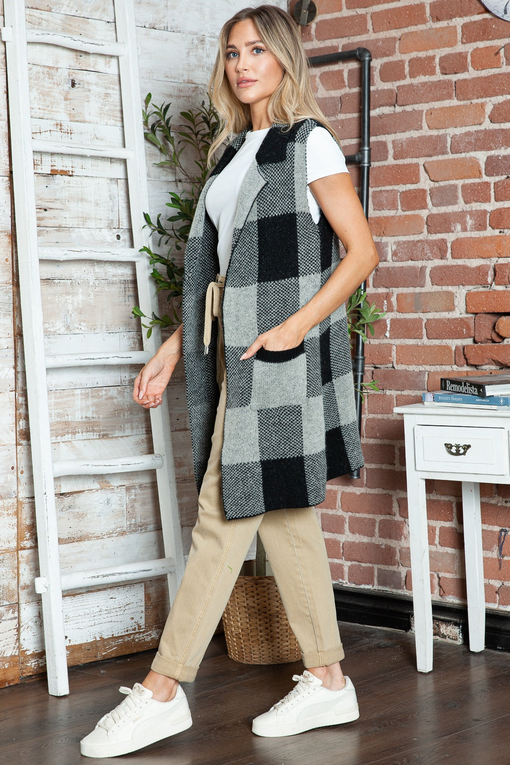 Black and grey checkered knit duster vest with pockets and a shawl collar.