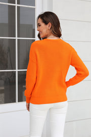 Orange ribbed knit V-neck sweater with long sleeves and a relaxed fit.