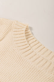 Cream ribbed knit pullover sweater with textured knit detail and ribbed neckline.