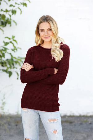 Burgundy honeycomb knit pullover sweater with raglan sleeves and crew neck.