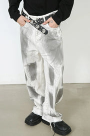 Brushstroke denim wide leg jeans in light with raw hem and abstract grey pattern.