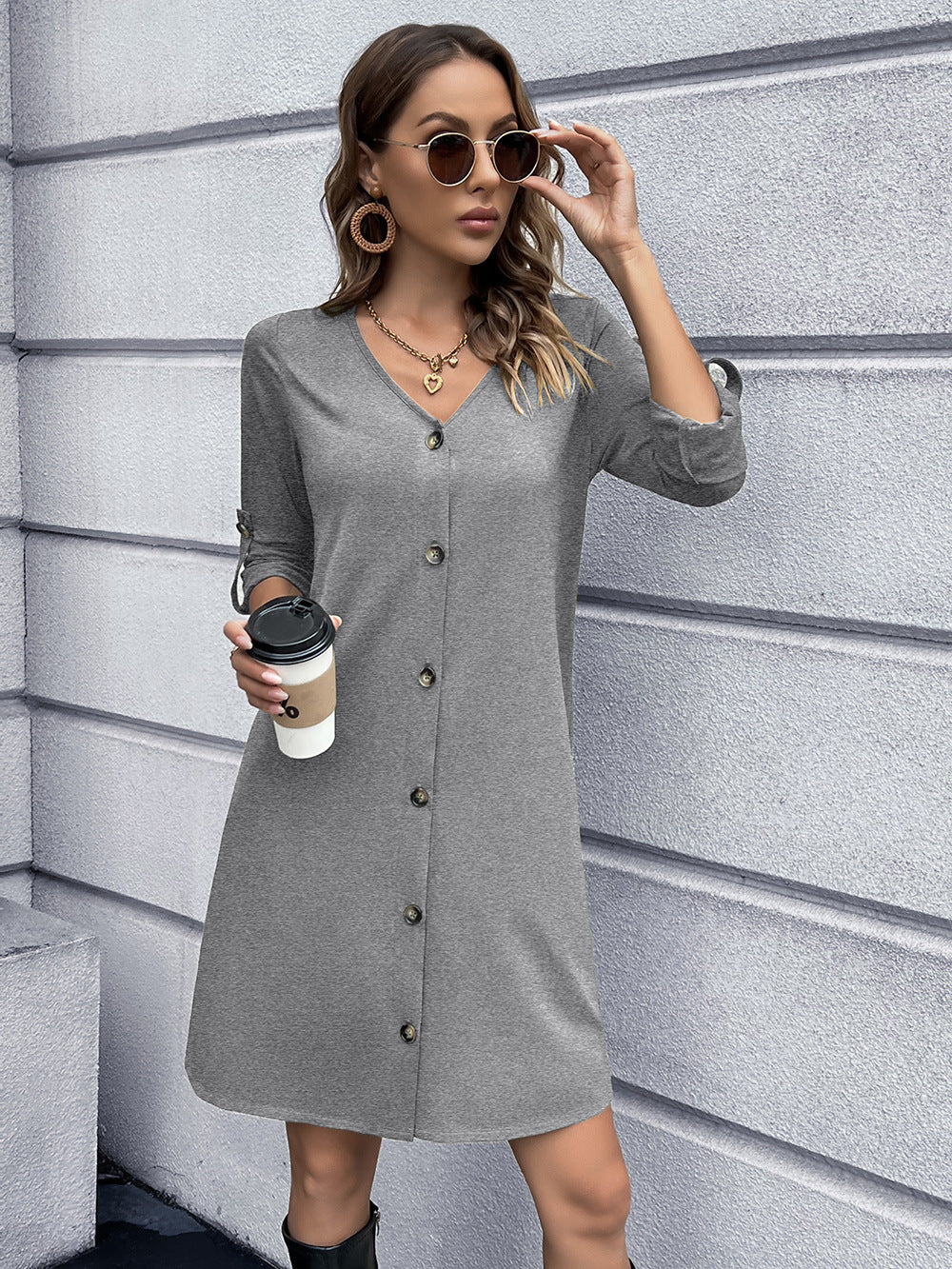 Light gray button-down mini dress with V-neck and roll-tab sleeves.