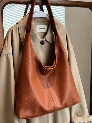 Brown pebbled leather hobo shoulder bag with slouchy silhouette and comfortable strap.
