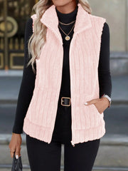 Pink fuzzy fleece zip-up vest with pockets and a stand-up collar.