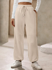 Tan balloon-leg sweatpants with drawstring waist and pockets